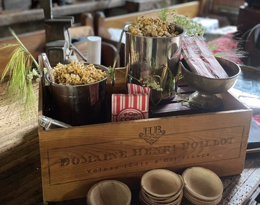 Wooden box with popcorn and garnishes