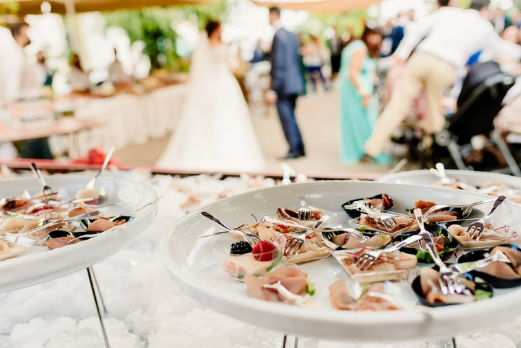 wedding appetizers with bride in the background