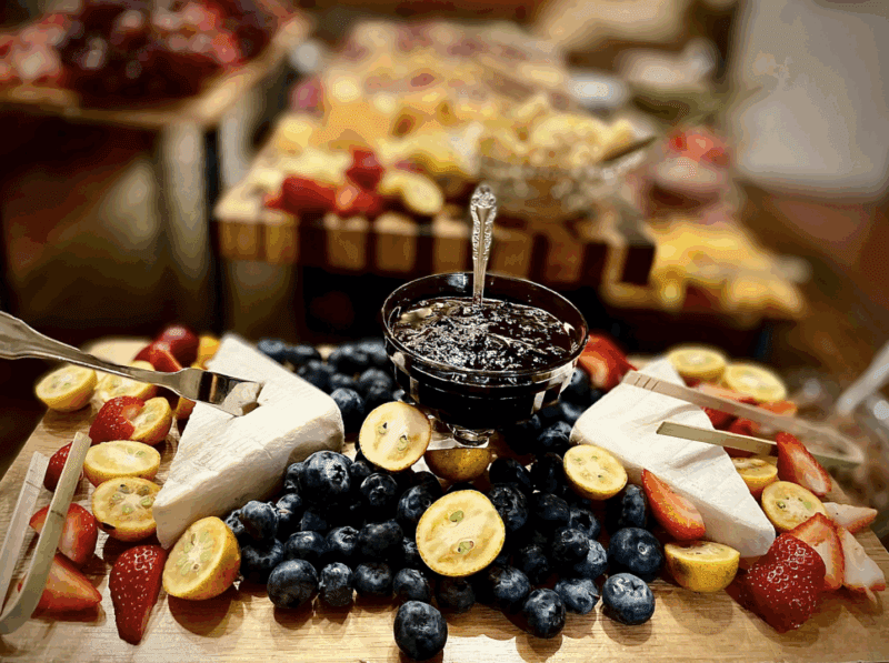 a cheese and fruit board set up on a table